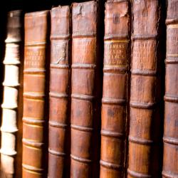 Antique books on a shelf image: University of Cambridge