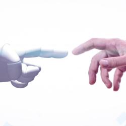 Human hand touching robot hand
